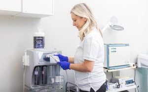 Esthetician disinfecting skincare equipment with Prevention Disinfectant Wipes