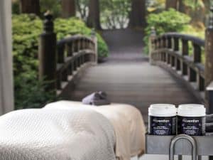 Prevention Disinfectant Wipes beside a massage table in a spa treatment room