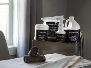 Prevention Disinfectant Wipes and Ready-to-Use Spray kept close at hand in a massage treatment room