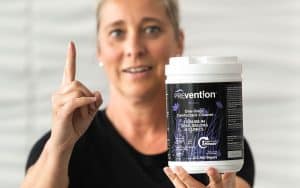 Spa professional holding Prevention Disinfectant Wipes and emphasizing the one-minute contact time