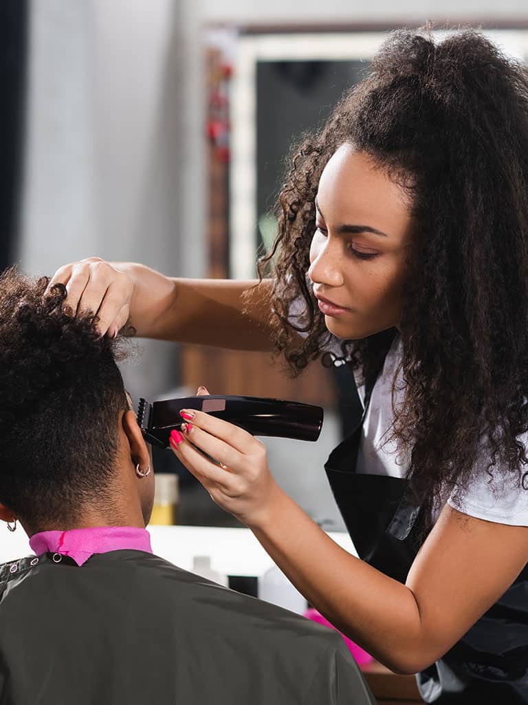 Hair stylist in a salon with her client