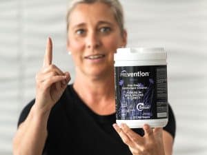 Spa professional holding Prevention Disinfectant Wipes and highlighting the one-minute contact time