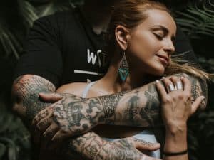 Couple with tattoos showing the importance of infection prevention