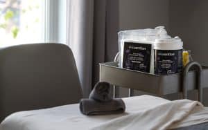 Massage treatment room with Prevention Disinfectant Wipes and refill pouch
